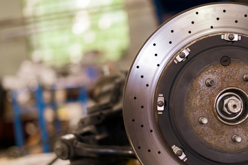 close up metal chrome brake disk, repair vehicle parts of the sport car