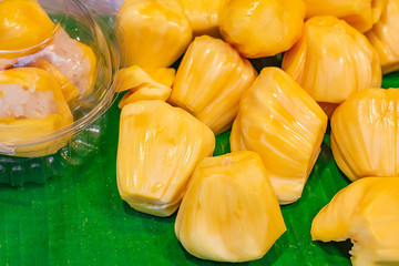 Jackfruit placed on banana leaves. Jackfruit is a type of fruit that is yellow.