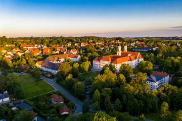 Fototapeta na wymiar Aerial view in the early morning, Irsee, Benedictine monastery in Irsee, Diocese of Augsburg, Bavaria, Germany,