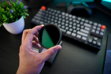 A man hand holding a variable ND (Nuetral Density) filter