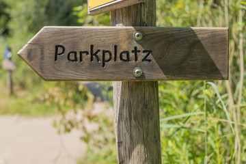 wooden arrow with german inscription for parking place