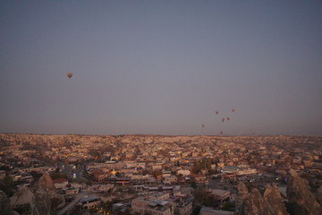 Hot air balloon flying over rock landscape at Cappadocia Turkey
