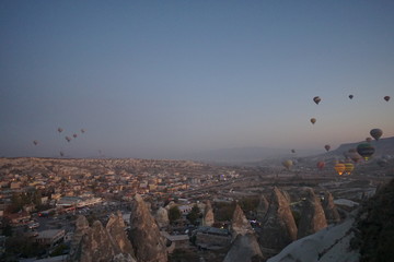 Hot air balloon flying over rock landscape at Cappadocia Turkey