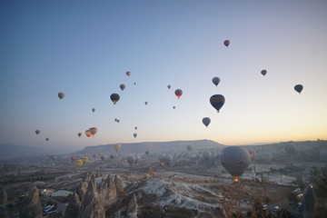 Hot air balloon flying over rock landscape at Cappadocia Turkey