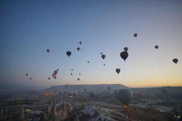 Hot air balloon flying over rock landscape at Cappadocia Turkey