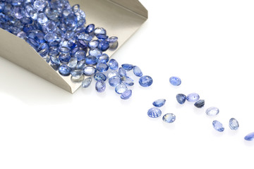 Precious blue sapphires on a jeweler's shovel. Precious polished stones.