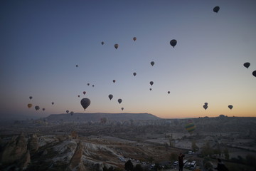 Hot air balloon flying over rock landscape at Cappadocia Turkey