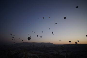 Hot air balloon flying over rock landscape at Cappadocia Turkey