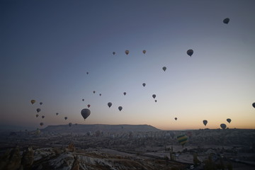 Hot air balloon flying over rock landscape at Cappadocia Turkey