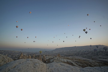 Hot air balloon flying over rock landscape at Cappadocia Turkey
