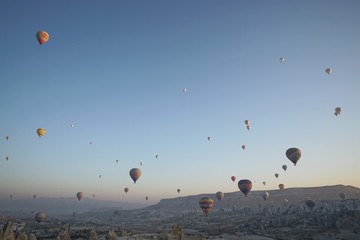 Hot air balloon flying over rock landscape at Cappadocia Turkey