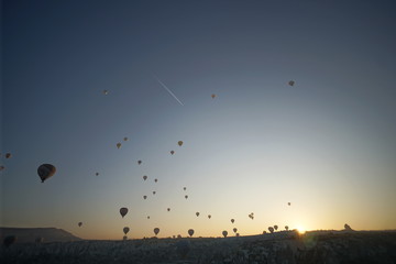Hot air balloon flying over rock landscape at Cappadocia Turkey