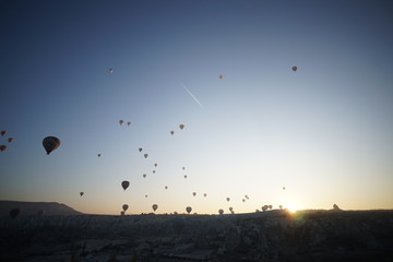 Hot air balloon flying over rock landscape at Cappadocia Turkey