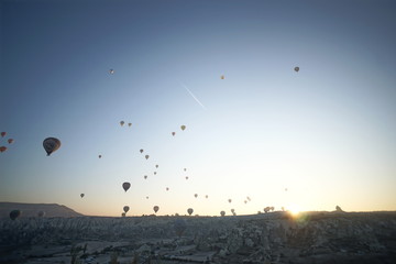 Hot air balloon flying over rock landscape at Cappadocia Turkey