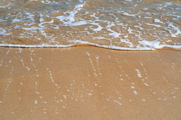 Fototapeta na wymiar Waves on the sandy beach. Selektive focus. Travel and tourism background with copy space. 