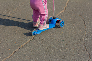 A small child learns to ride a scooter in the Park. © Елена Николаева
