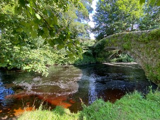 Old stone bridge over the Walden Beck, on a sunny day in, West Burton, Leyburn,UK