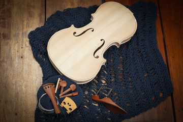 Raw violin and accessories put on background