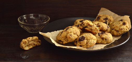 Homemade chocolate chip vanilla cookies on a dark background