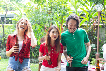 Group of friends having fun and happy in barbecue party at house backyard