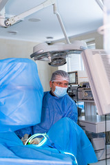 Invasive surgical system. Modern automated medical device. Surgical room in hospital with robotic...