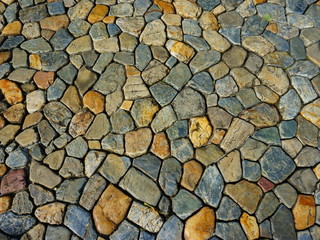 Background of multi-colored stones on the road