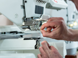 Fabric industry production line. Textile factory. Working tailoring process