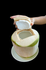 Young coconut die cut on black isolated