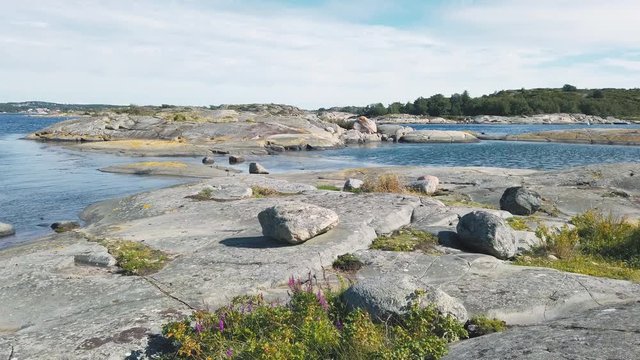 Scenic landscape view of Rauk fields, estuaries, rock, stone and outcroppings on sunny blue sky day, Gotland, Sweden, handheld pan