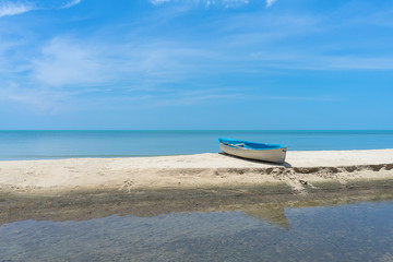 One boat on the beach with sky background.