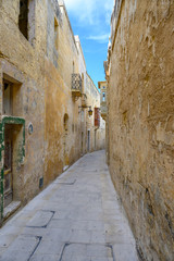 Fototapeta na wymiar Narrow street in the ancient Maltese city of Mdina on the island of Malta.
