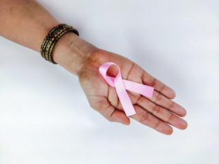 woman Hand holding pink ribbon , Breast cancer awareness symbol, fight against cancer