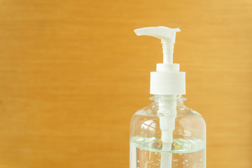 Close up view of alcohol hand sanitizer gel in plastic bottle with dispenser pump used for killing disease, bacteria and virus with city view background. Pandemic protection concept.