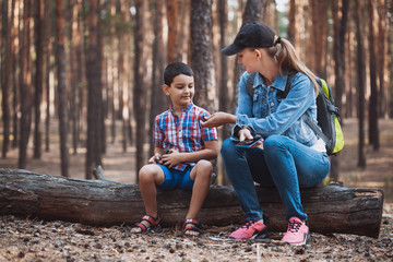 mother and son are walking in a pine forest. Tourism, outdoor activities