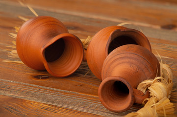 Still life with clay jugs on a wooden table.