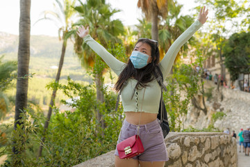 lifestyle portrait  of young happy and cheerful Asian Korean tourist woman visiting Spain during Summer holidays travel hiking and enjoying nature from beautiful viewpoint