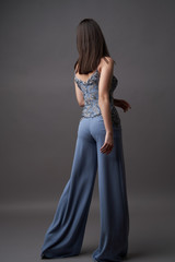 Fototapeta premium Portrait of a beautiful woman in trendy bodysuit trousers
