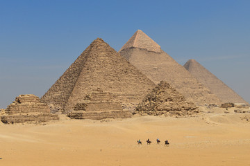 Five horse riders in Giza Pyramids in Cairo - Egypt