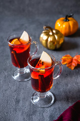 Two glasses of christmas mulled wine with oranges and spices. Winter drink traditional for the Christmas holidays.