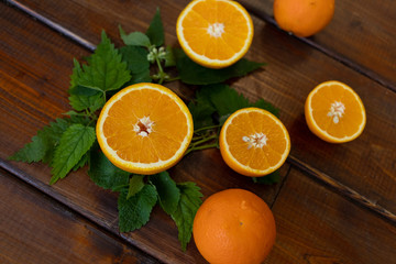 cut oranges on a brown wooden background, top view, text space, citrus fruits