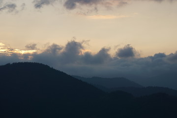 A mystical and fabulous sunset over a mountain with clouds