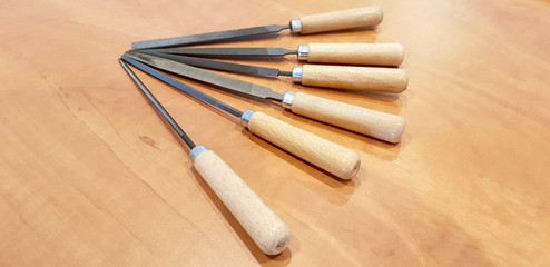 Close up shot of warding file assortment on a wooden table
