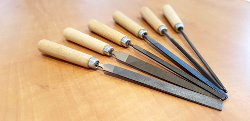 Close up shot of warding file assortment on a wooden table