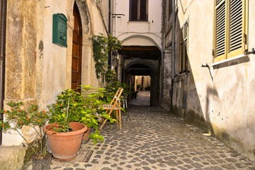 Fototapeta na wymiar A narrow street among the old houses of Giuliano di Roma, a rural village in the Lazio region.