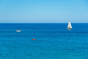 Obraz premium Wonderful Mediterranean coast beach in Puglia, South Italy, with blue sea and boats