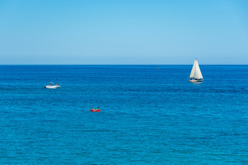 Wonderful Mediterranean coast beach in Puglia, South Italy, with blue sea and boats