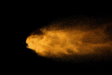 Fototapeta na wymiar Closeup of orange powder particle splash isolated on black background.