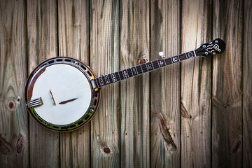 5 String Banjo on a brown rustic natural wood background
 - obrazy, fototapety, plakaty