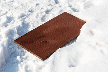 Old furniture board lying in the snow