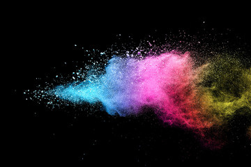 Explosion of colored powder isolated on black background. 